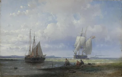 Pescatori che riparano le reti sulla spiaggia